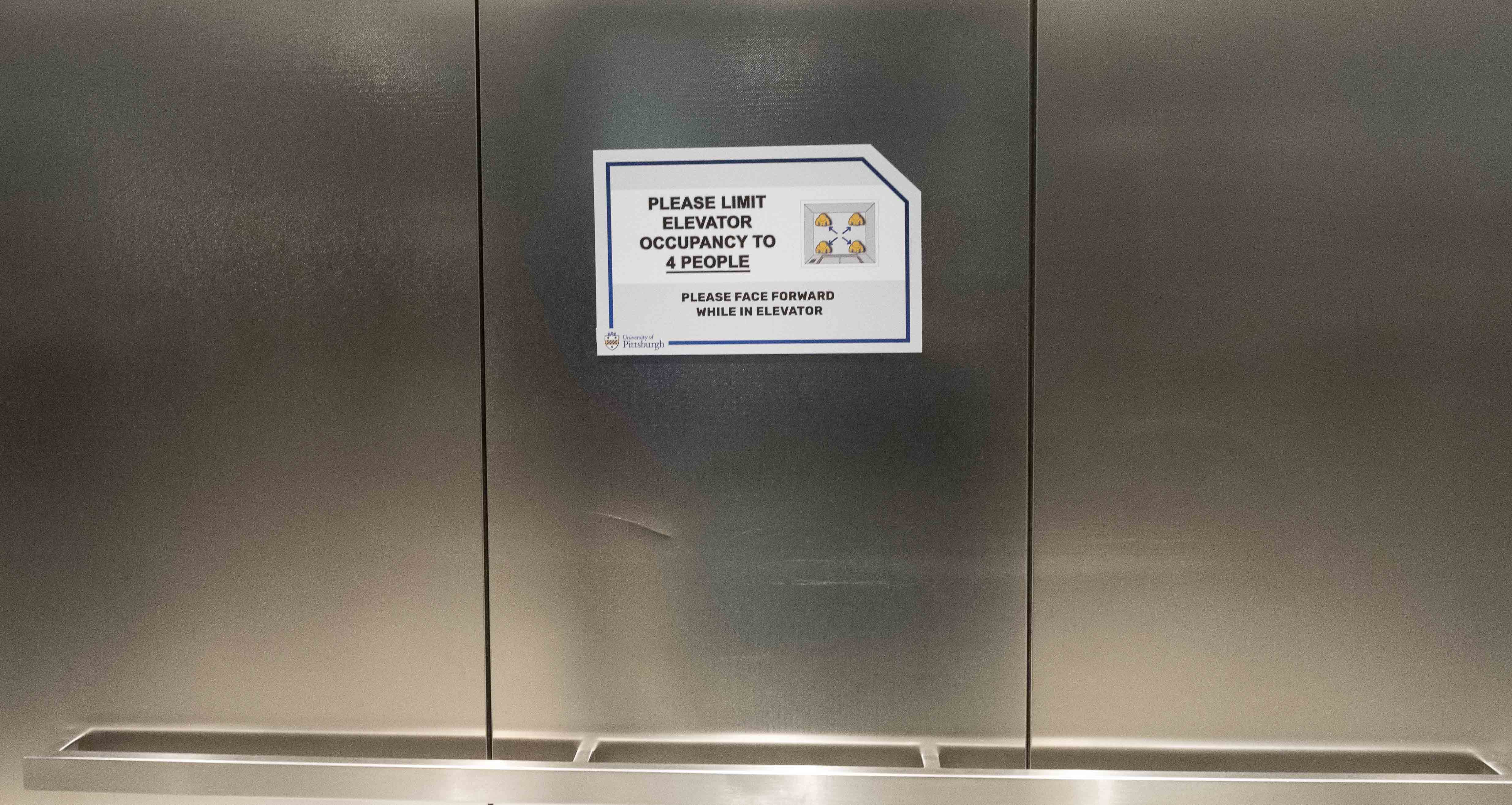 Sign with elevator capacity limits