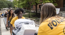 Student volunteers help people move in