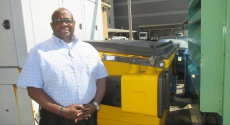 Ernest Robinson in front of yellow composter