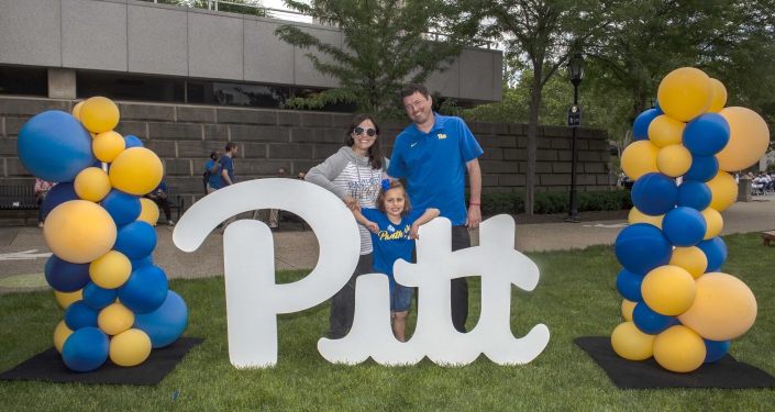 Family at Pitt sign