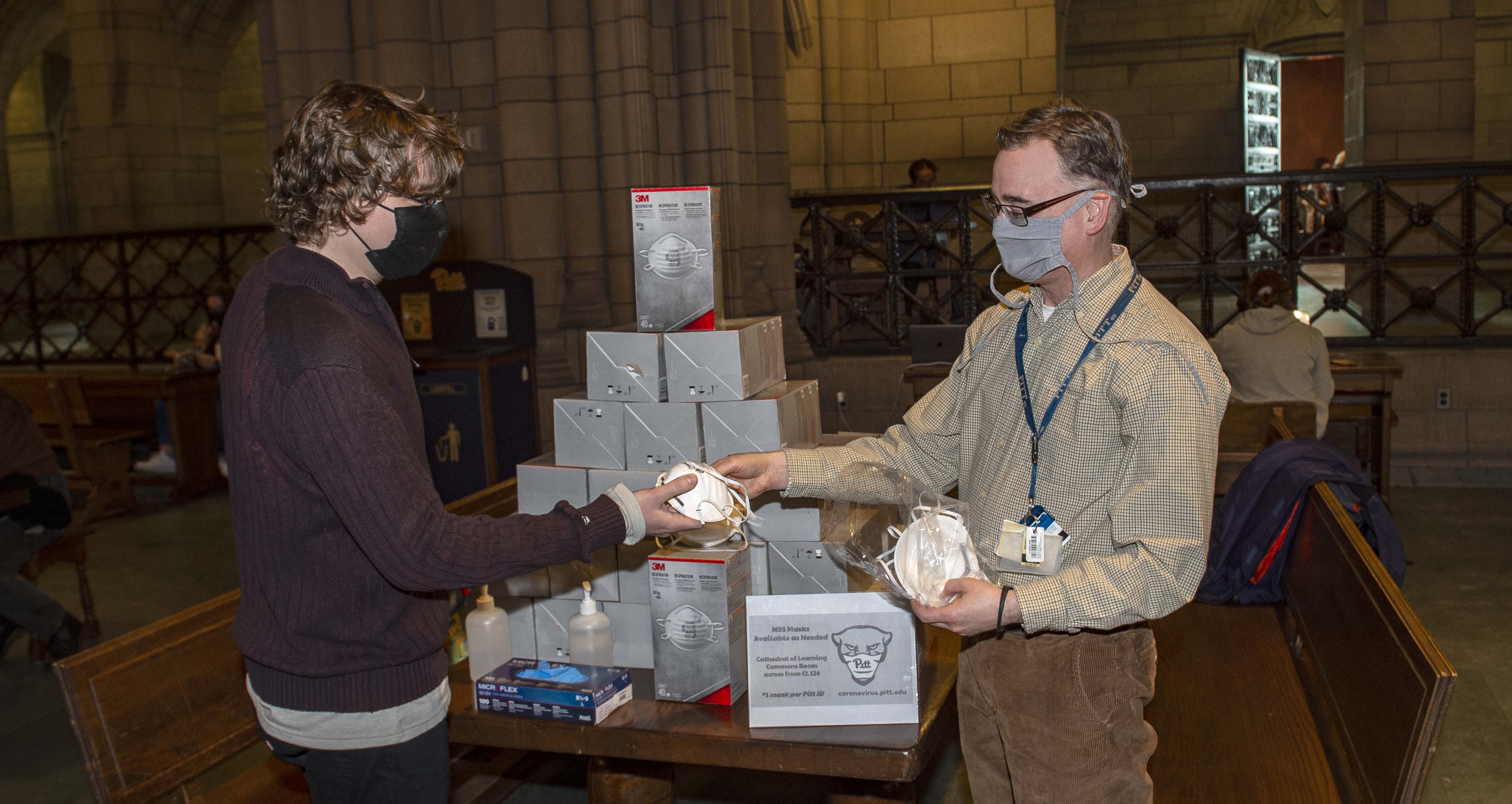 Person handing out N95 masks in the Cathedral