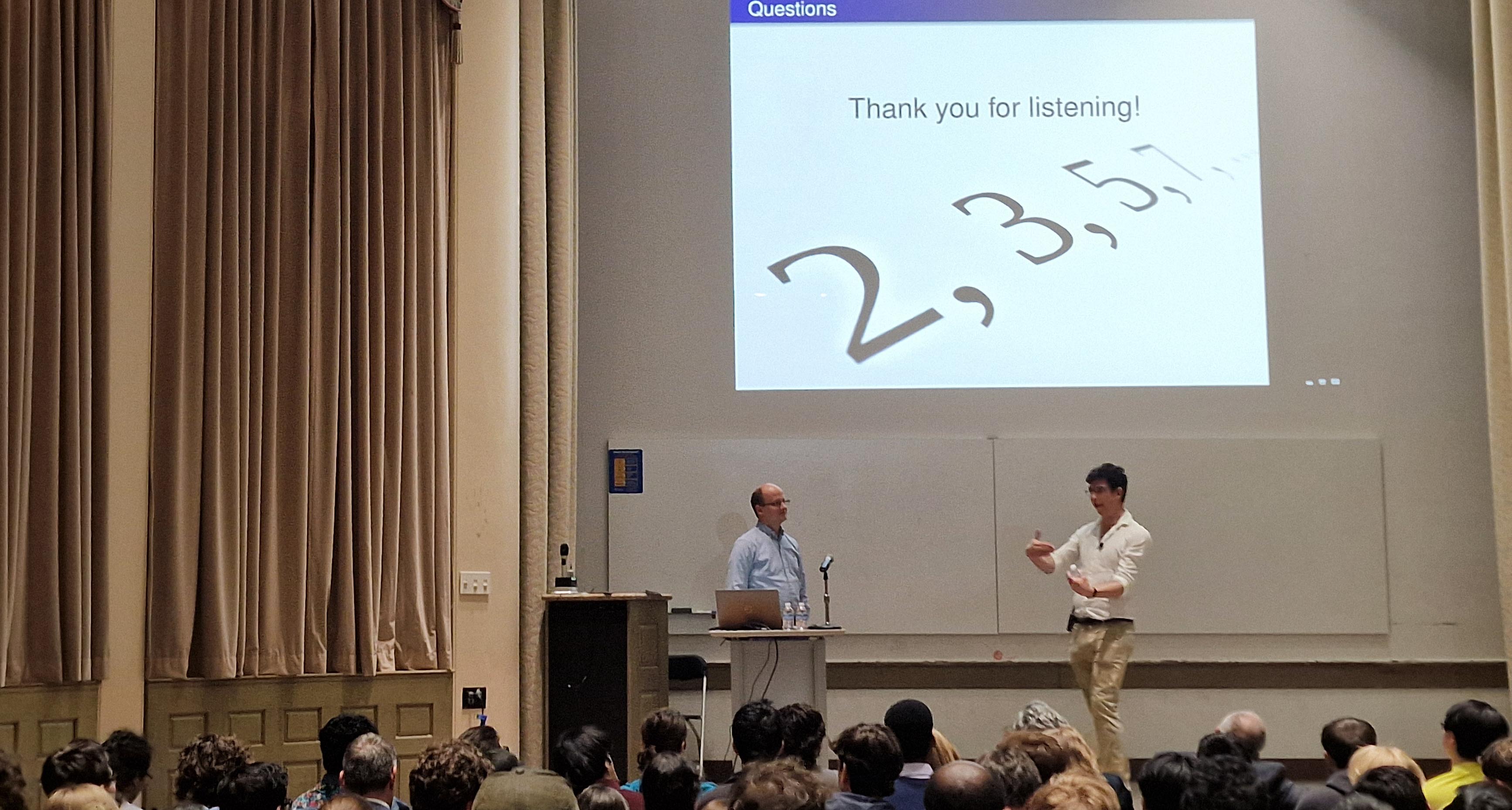 James Maynard (right), winner of the 2022 Fields Medal in mathematics, gave two lectures to packed crowds during his visit to Pittsburgh in March. Two men on stage