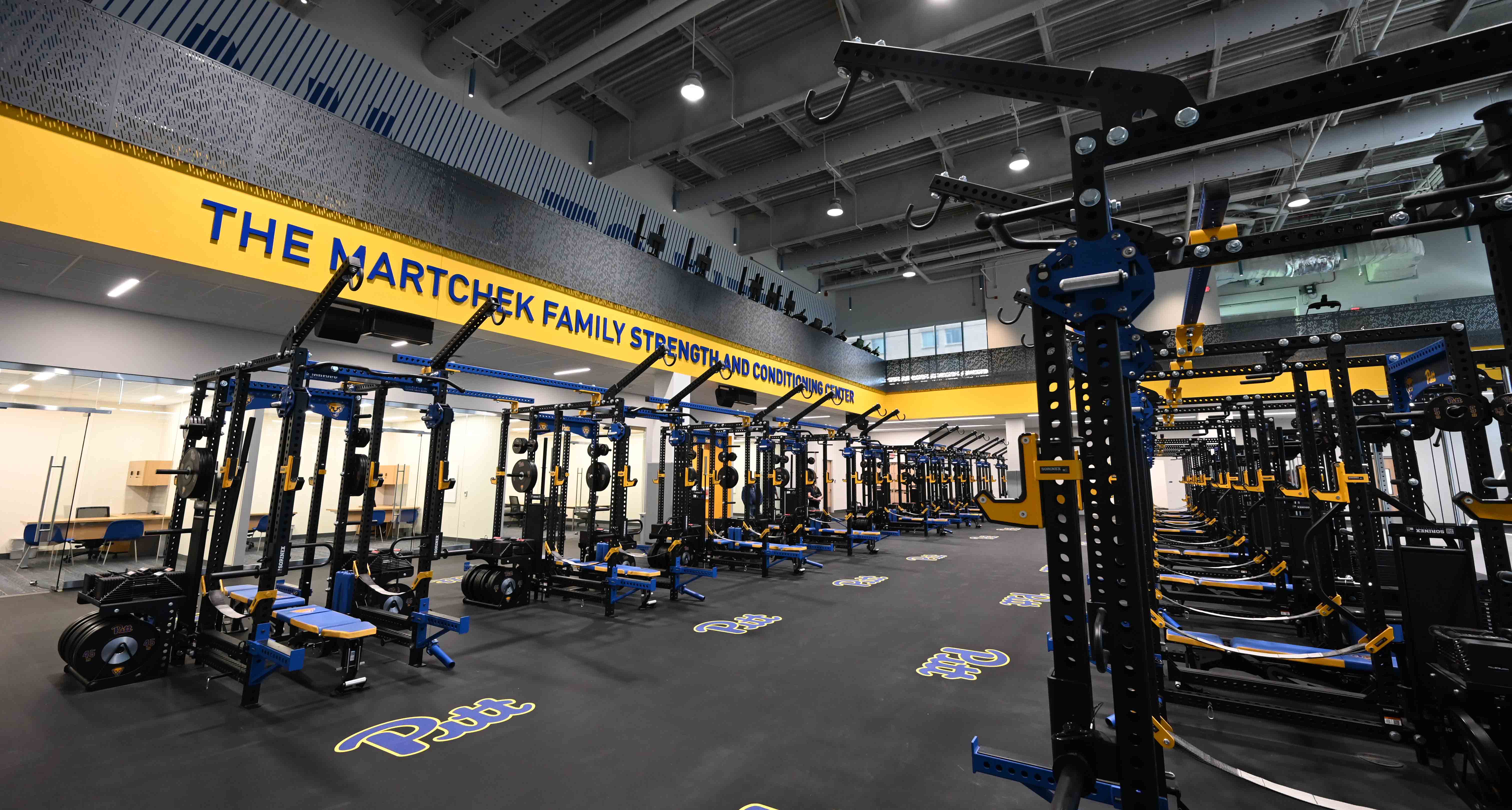 The main floor of the Martchek Family Strength and Conditioning Center has a variety of weight benches and equipment.
