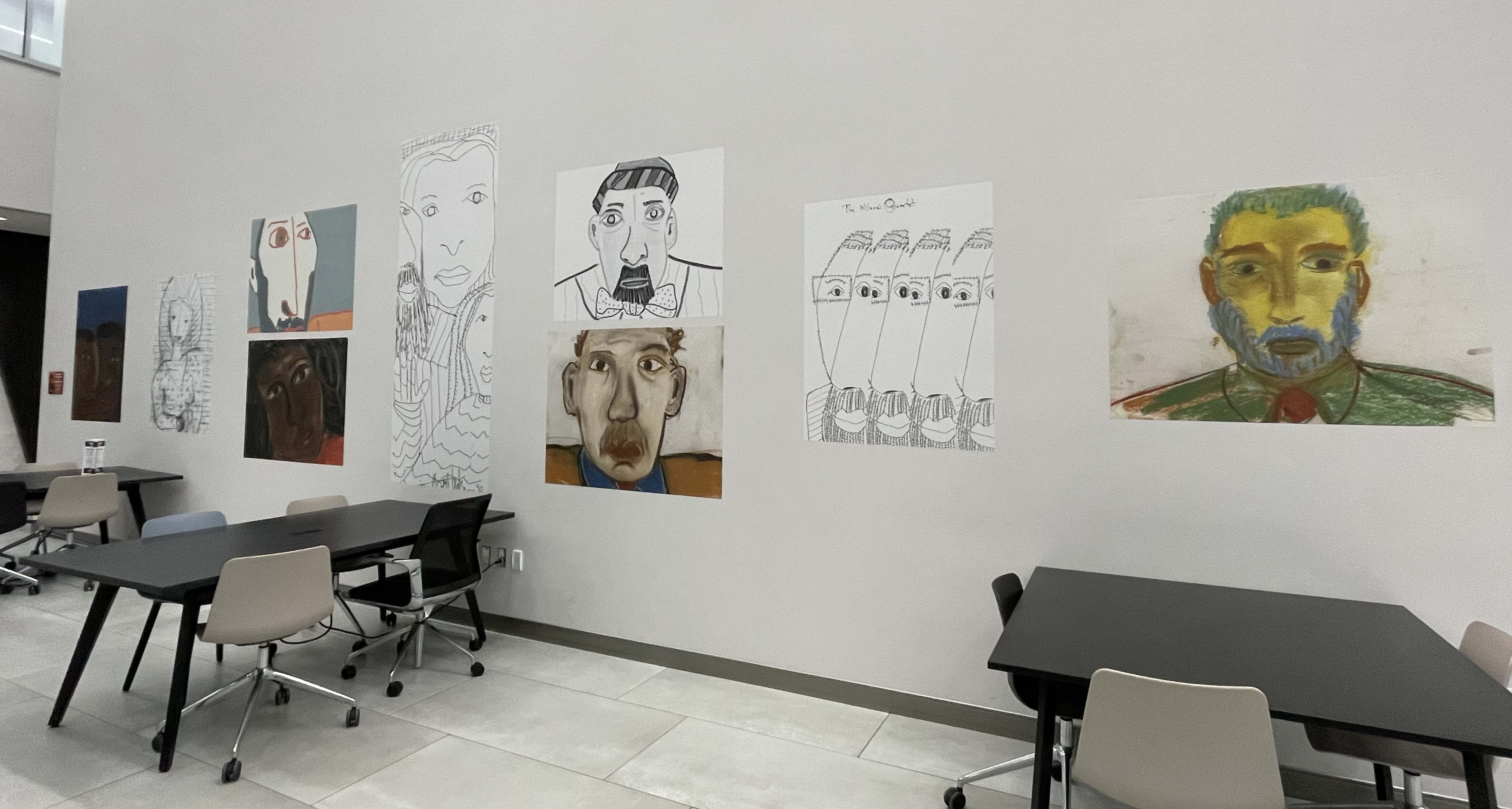Large copies of paintings and drawings by August Wilson line the event space on the first floor of Hillman Library. (Susan Jones | University Times) Blown up images of August Wilson drawings