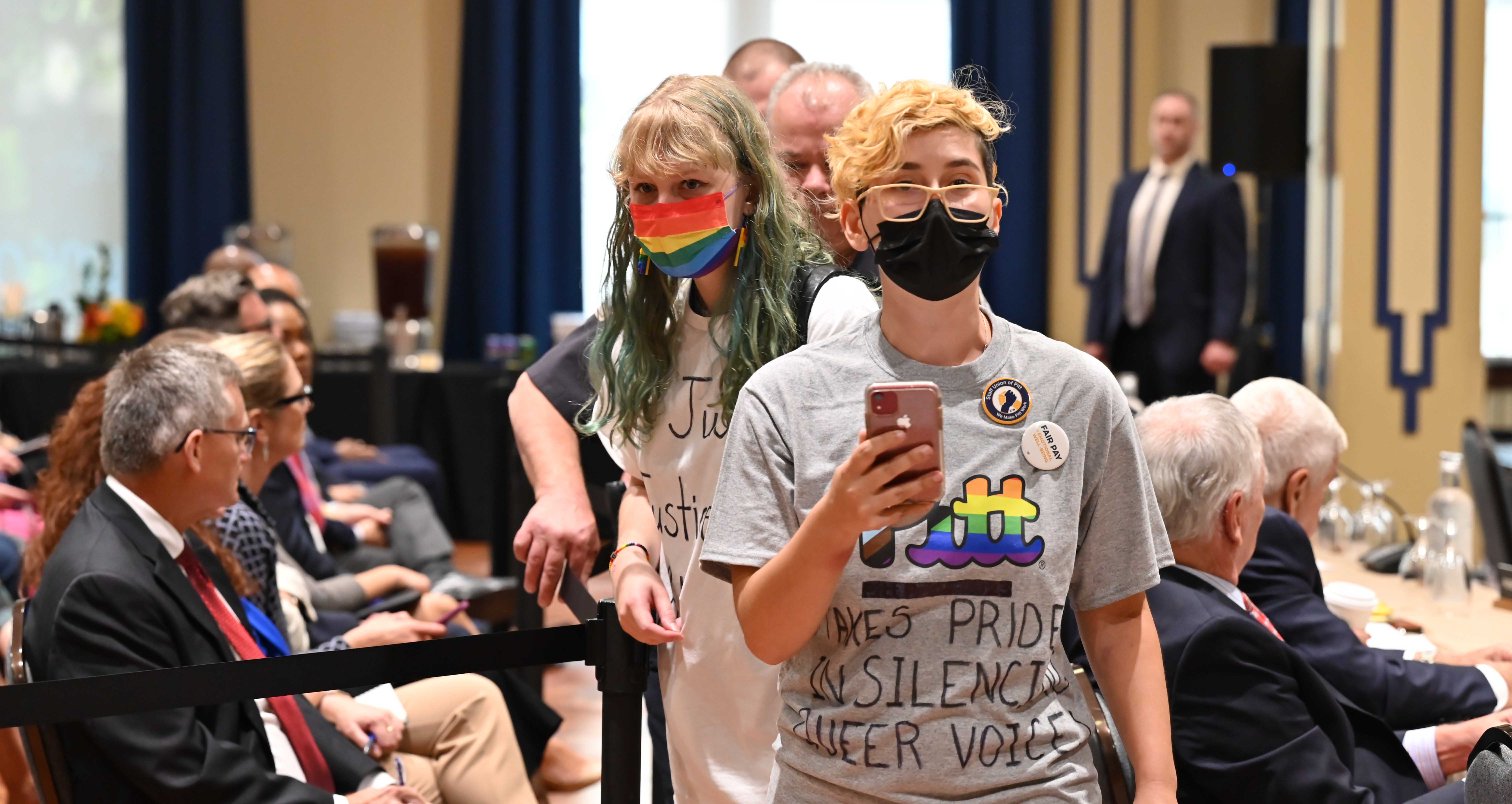 Student supporters of transgender rights and other LGBTQIA+ issues are escorted out of the Board of Trustees meeting on Sept. 29 after disrupting voting for a new chair. (Aimee Obidzinski | University of Pittsburgh) Protesters led out of meeting