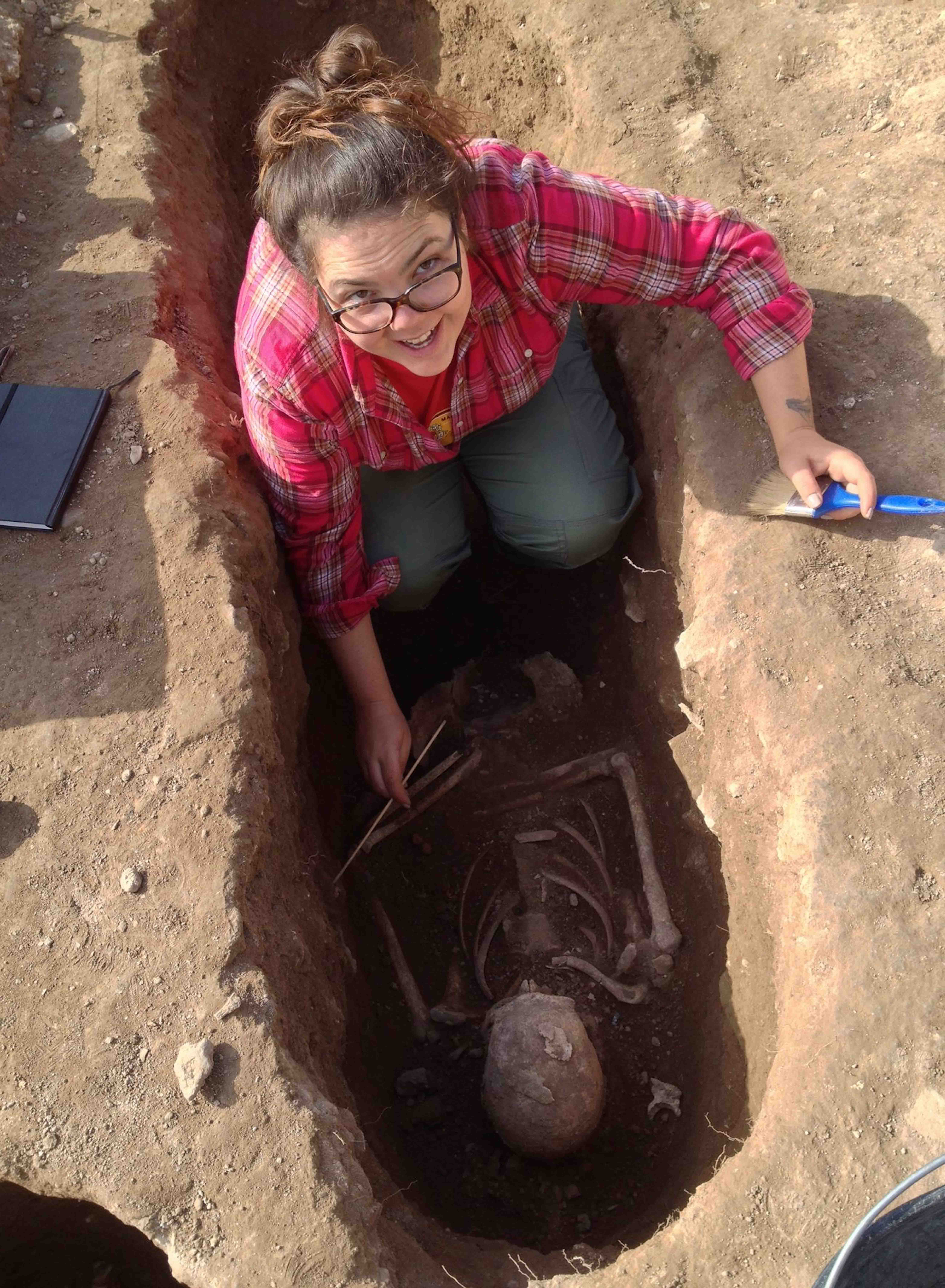 Maggie Beeler excavating an ancient grave in Greece
