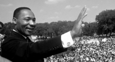 Martin Luther King Jr. waves to crowd