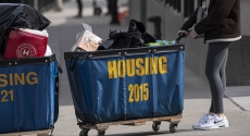 Person pushing housing bin