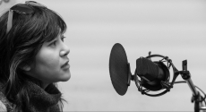 Woman speaking into microphone
