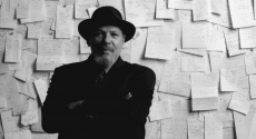 August Wilson in front of board full of papers