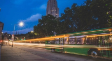 Bus trailing lights near Cathedral of learning
