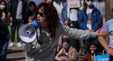 Actress Sandra Oh speaking with bullhorn