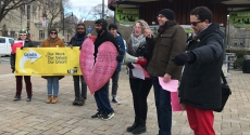 Protesters with cardboard broken heart