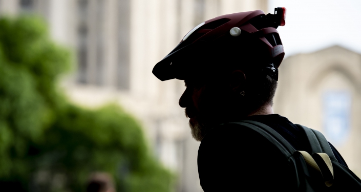 silhouette of man in bike helmet